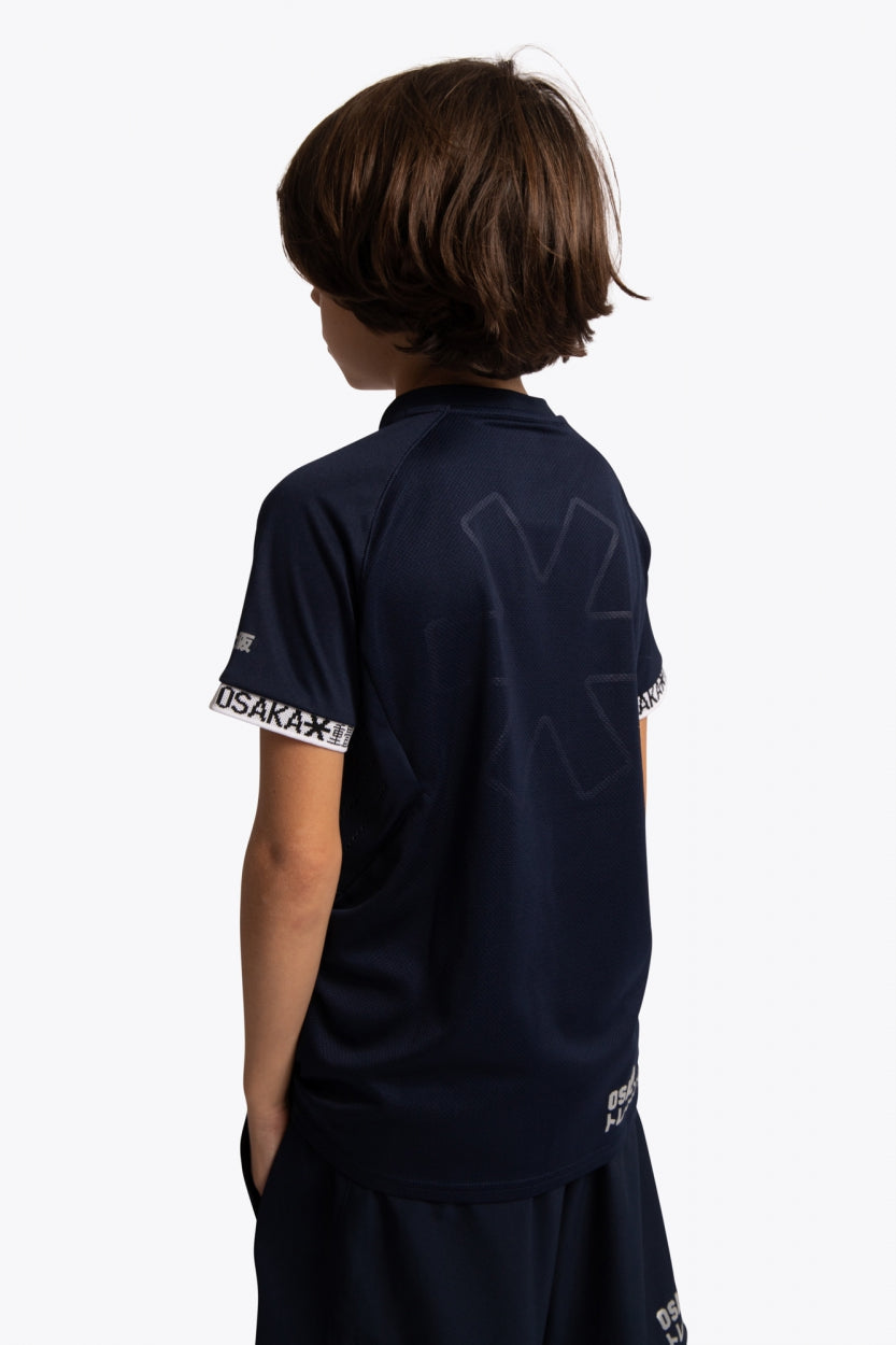 Boy wearing the Osaka Kids Jersey in Navy. Back view