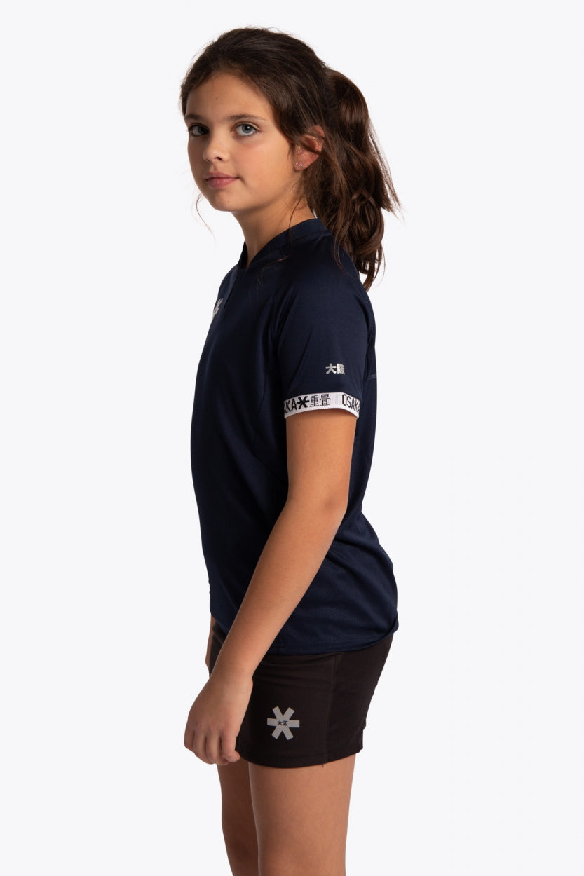 Girl wearing the Osaka Kids Jersey in Navy. Side view