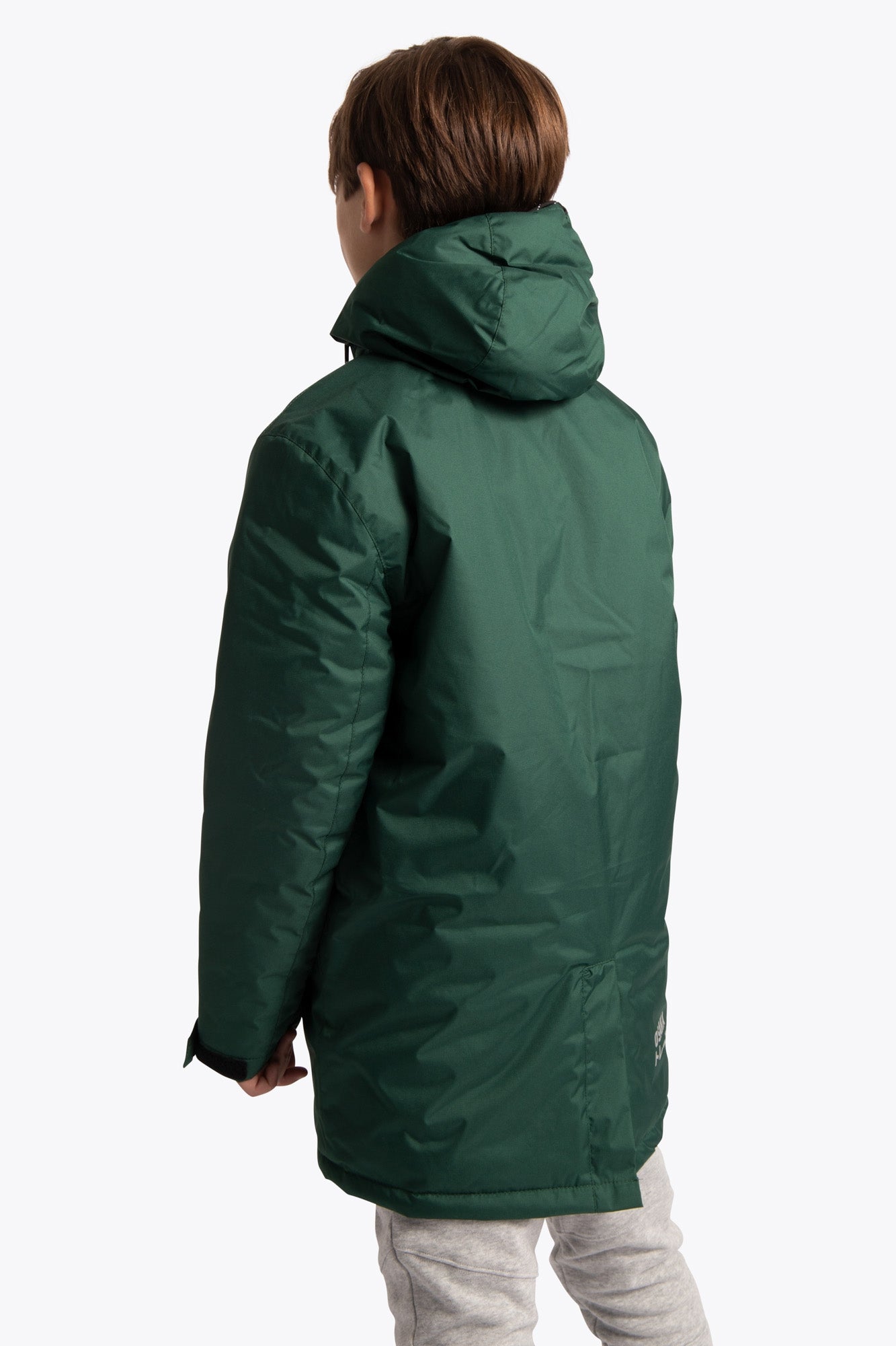 Boy wearing the Osaka Kids Stadium Jacket in Dark Green. Back view