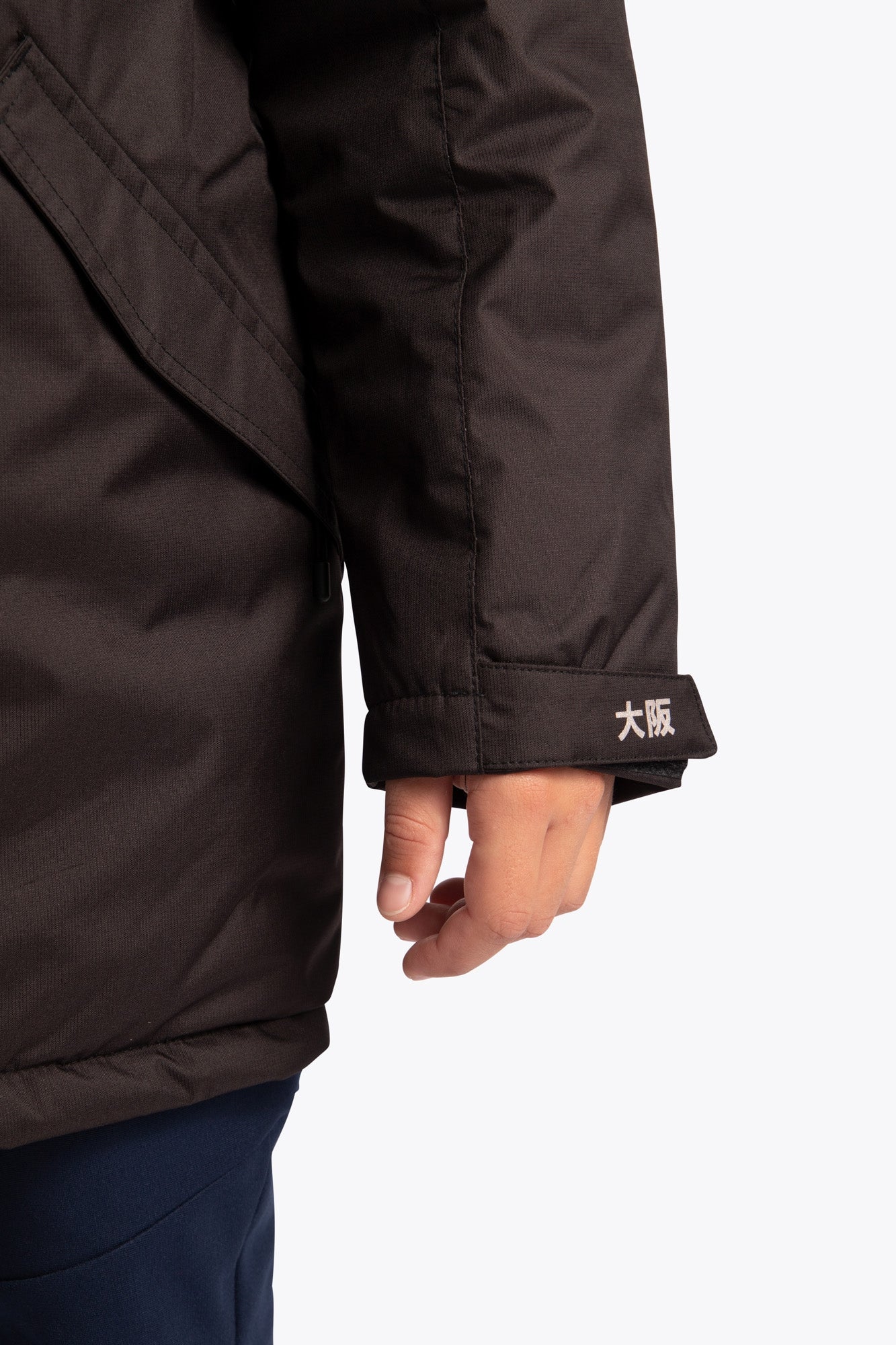 Osaka Kids Stadium Jacket in Black. Detail logo sleeve view