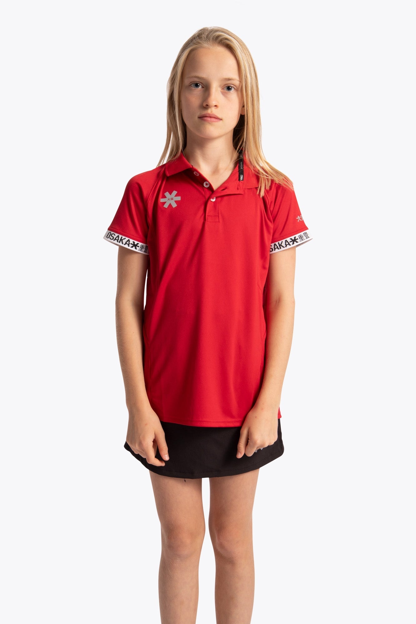 Girl wearing the Osaka Kids Polo Jersey in Red. Front view