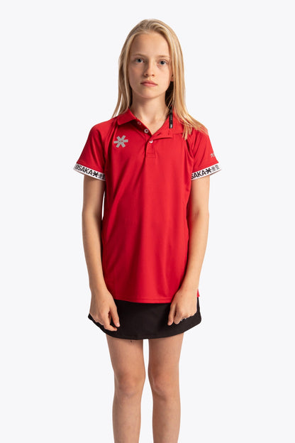 Girl wearing the Osaka Kids Polo Jersey in Red. Front view