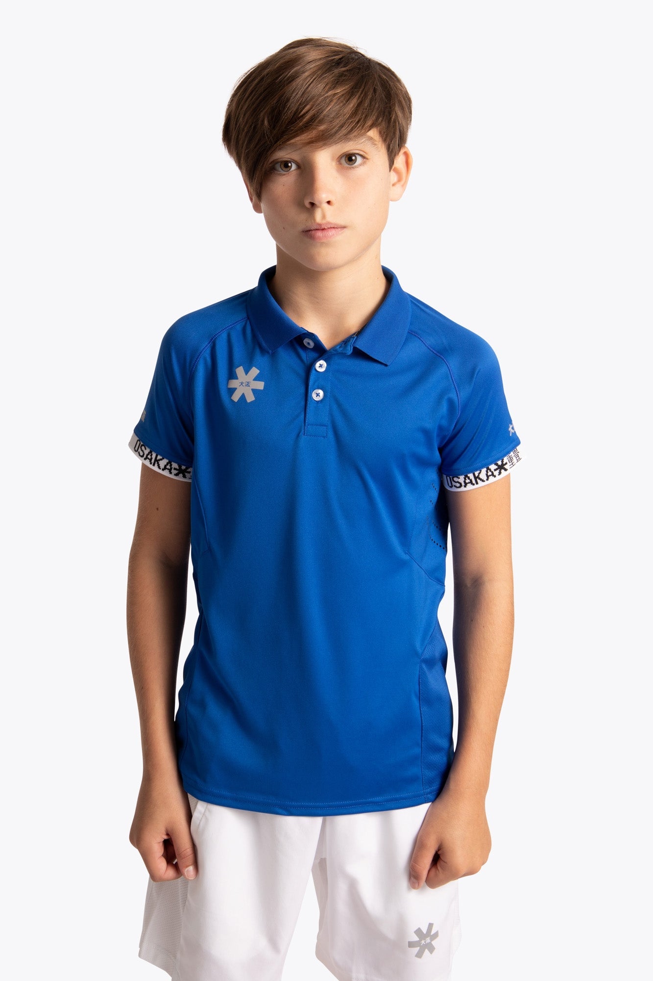 Boy wearing the Osaka Kids Polo Jersey in Royal blue. Front view