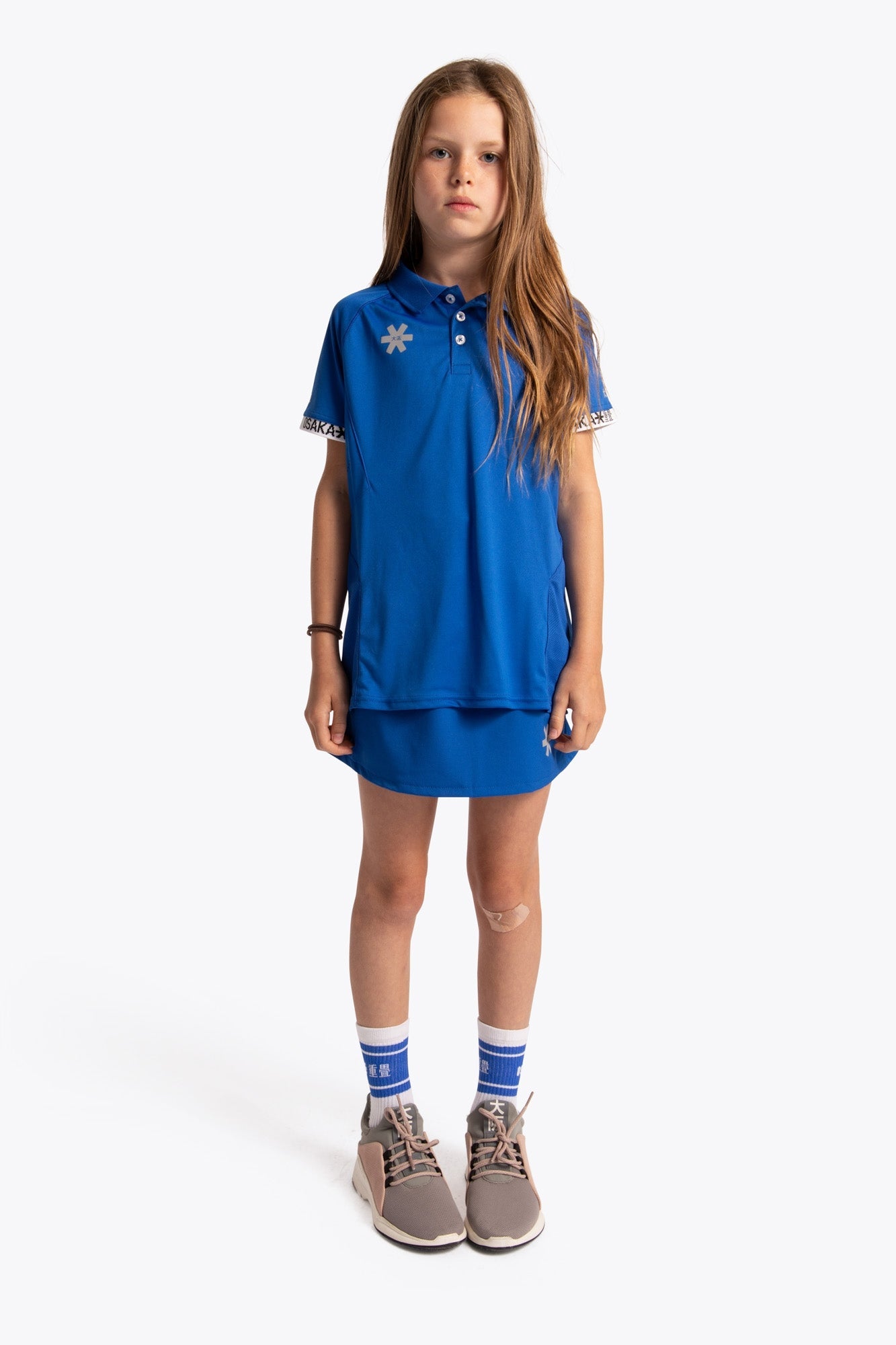 Girl wearing the Osaka Kids Polo Jersey in Royal blue. Front view
