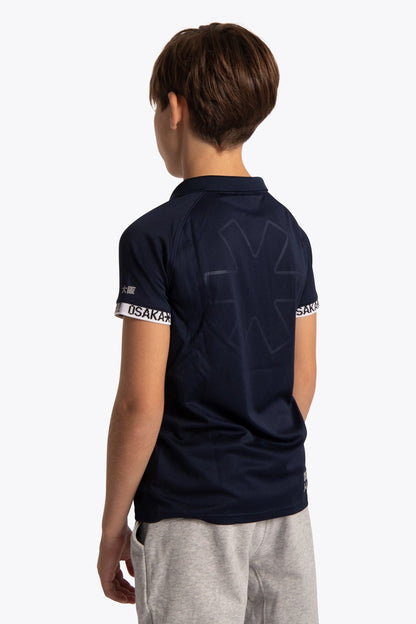 Boy wearing the Osaka Kids Polo Jersey in Navy. Back view