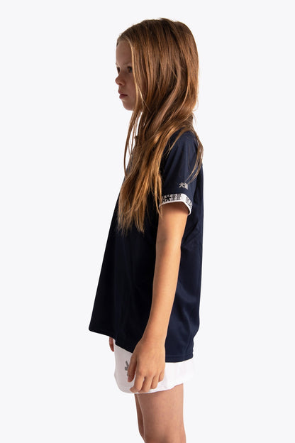 Girl wearing the Osaka Kids Polo Jersey in Navy. Side view