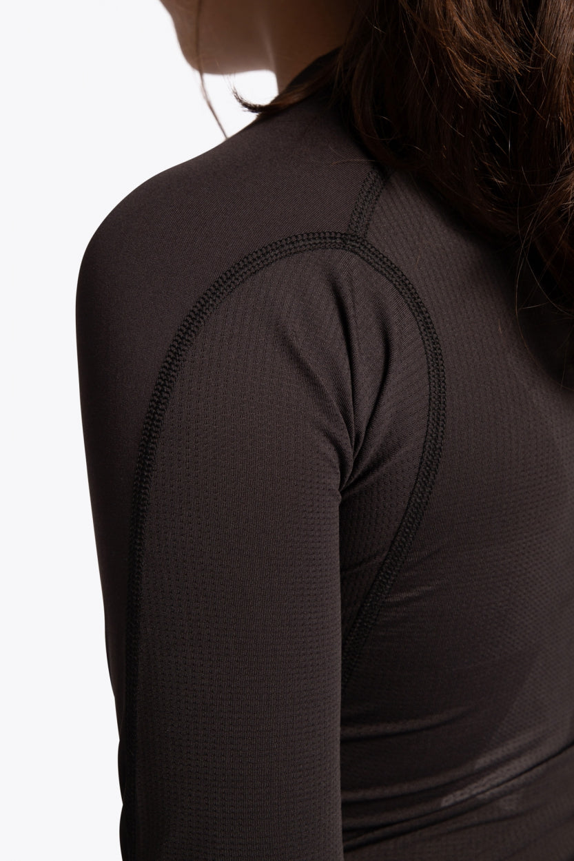 Kid wearing the Osaka Kids Baselayer Top in Black. Back detail sleeve view